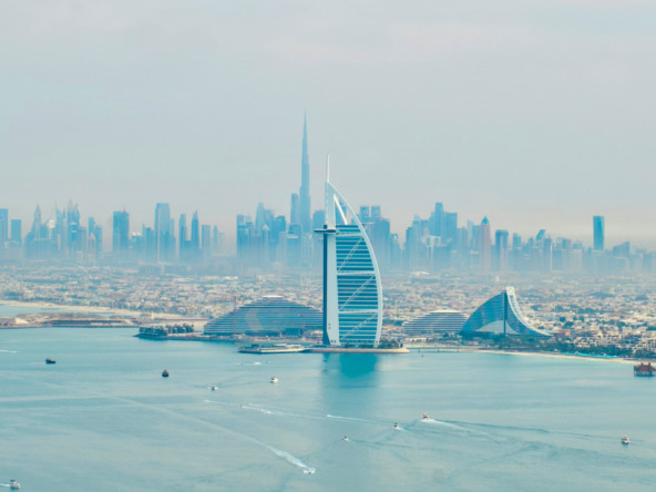 Dubai skyline with construction cranes reflecting off-plan property growth